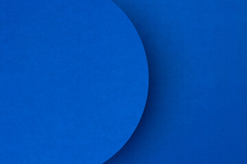 Bright blue textured paper surface with semi circle