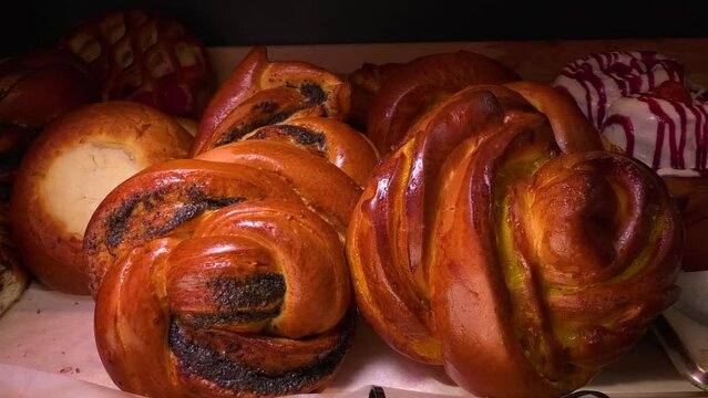 Freshly baked fresh buns, cheesecakes and synabons lie on a tray. Homemade pastries. Craft pastries.