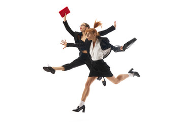 Fototapeta premium Multitasking and professional competition. Ambitions and motivated women in formal wear in dynamic pose running forward with documents isolated on white background. Concept of business, office life