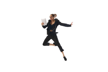 Happy businesswoman in formal wear jumping and emotionally looking on tablet isolated on white background. Project and budgeting approval. Concept of business, office lifestyle, success, growth