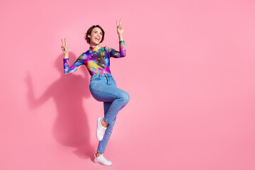 Full body portrait of pretty girl demonstrate v-sign empty space wear pullover isolated on pink color background