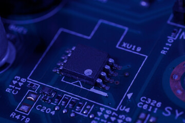 Fototapeta premium Close-up view of an integrated circuit mounted on a green printed circuit board.