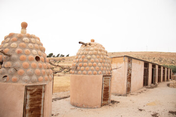 Rustic bee hives made of mud, in modern days it is supported with cement for birds to live in with...