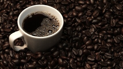 Top view of coffee or espresso with piles of coffee beans. Close up of fresh roasted coffee bean...