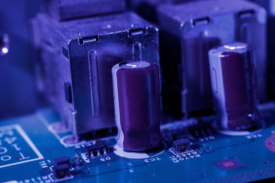 Close-up view of capacitors on a green printed circuit board (PCB)