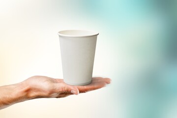 Woman hand hold takeaway paper cup of coffee