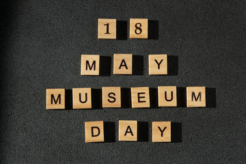 18 May date. Museum day wooden letters text black background.