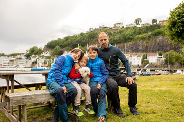 Child, visiting little town in south Norway, Arendal, on a rainy summer day