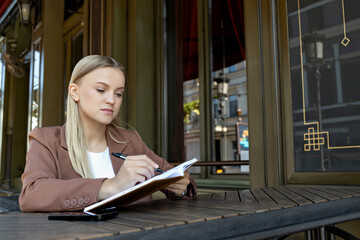 A girl in a business suit with a notebook.