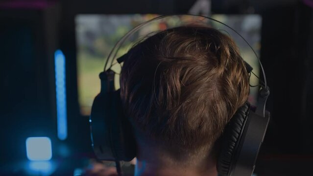 Esports tournament Gamer in headset plays video game PC Computer club Real-time strategy multiplayer online competition. Skill. Professional cyber sport championship. Modern gaming equipment earphones