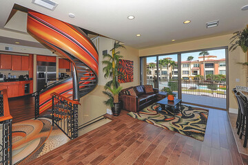 A modern living room featuring a sleek spiral staircase as a prominent architectural element
