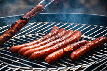 Grilled sausages on the barbeque grill top.