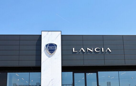 Tavagnacco, Italy. May 12, 2024. Lancia official dealership, with brand name and logo of the italian automaker on the facade