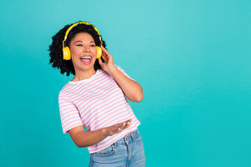 Photo of funny dj young woman with curly hair enjoying music her new loud stereo headphones...