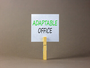 Adaptable office symbol. Concept words Adaptable office on beautiful white paper on wooden...