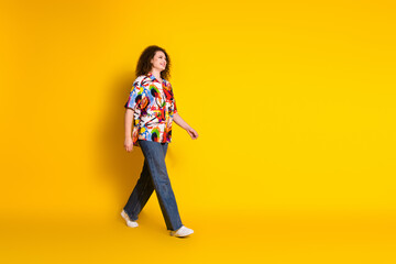Full size photo of attractive young woman walking empty space dressed stylish colorful print...