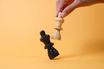 Hand moving chess figure in competition success play. Strategy, management or leadership concept.