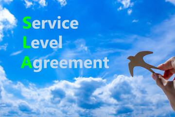 SLA service level agreement symbol. Concept words SLA service level agreement on beautiful blue sky...