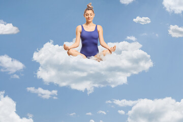 Young woman in a swimming suit sitting on a cloud