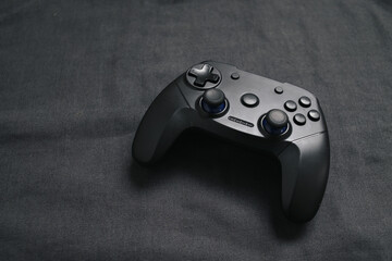 Black joystick on black background. Gaming concept.