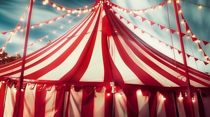 Vibrant Red and White Circus Tent Illuminated by String Lights at Twilight, Capturing the Magical Atmosphere of a Traveling Circus