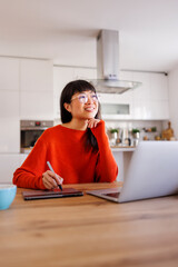 Female web designer working remotely from home