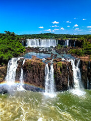 Top down aerial view of the picturesque Iguazu (Iguacu) Falls on the border of Brazil and Argentina in a national park surrounded by tropical forest and trees. Drone shooting