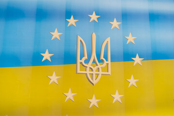 The flag of Ukraine, merges seamlessly with the circle of twelve golden stars from the emblem of the European Union, symbolizing unity and solidarity between Ukraine and the EU.