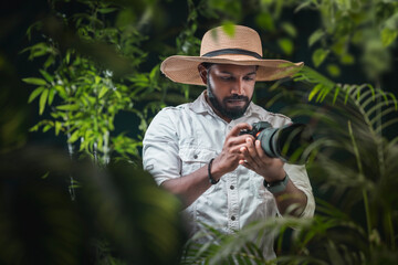 Wildlife adventure travel and tours concept image, young tourist photographer taking picture of...