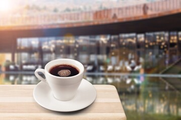 Wooden table at coffee shop with a cup