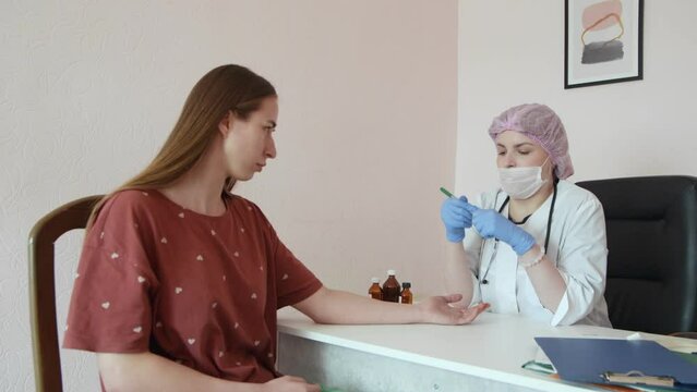 a female doctor gives a patient an allergy test
