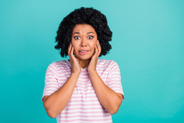 Photo portrait of lovely young lady touch face frightened dressed stylish striped garment isolated on aquamarine color background