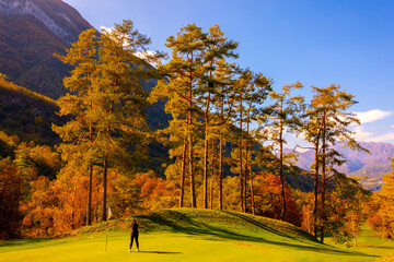 Golfer Putting on Putting Green on Golf Course Menaggio with Mountain View in Autumn in Lombardy,...
