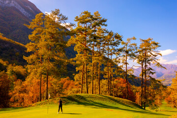 Golfer Putting on Putting Green on Golf Course Menaggio with Mountain View in Autumn in Lombardy, Italy.