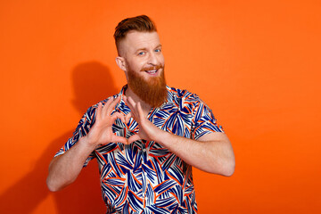 Photo of positive good mood guy dressed print shirt showing fingers heart emtpy space isolated...