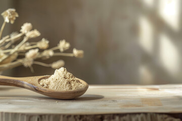 Wooden spoon filled with fine ashwagandha root powder is bathed in natural sunlight on a rustic wooden surface