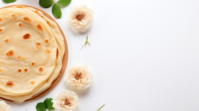 Top View Middle East Canai or Paratha Flat Bread, or also known as Roti Maryam in Indonesia with flower on white background