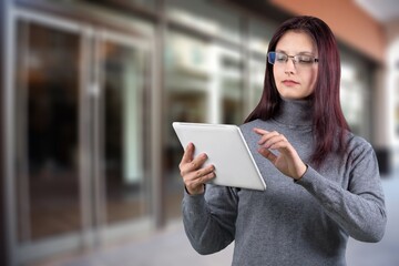 Fototapeta premium Smiling busy business manager hold tablet computer