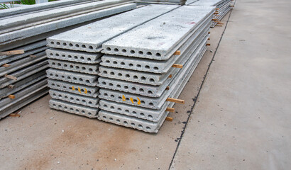 Stack of precast reinforced concrete slabs in house construction site.