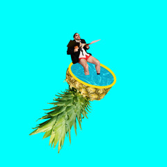 Quirky businessman in suit and boxers relaxes in floating pineapple pool against vibrant turquoise...