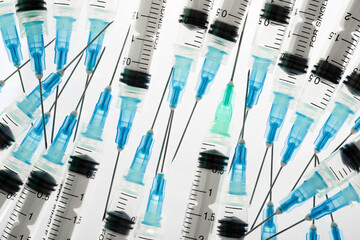 Hypodermic syringes on a white background