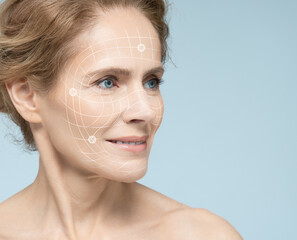 Mature female face with lifting lines showing skin lifting and facial contouring during cosmetic...