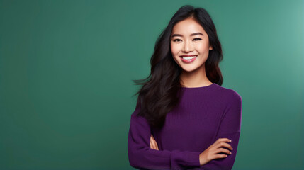 Fototapeta premium A young Asian woman with long black hair smiles at the camera. She is wearing a purple sweater.