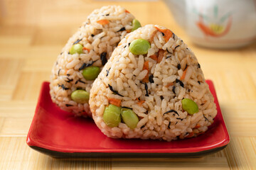 Plate with a pair of fresh homemade Japanese onigiri close up 