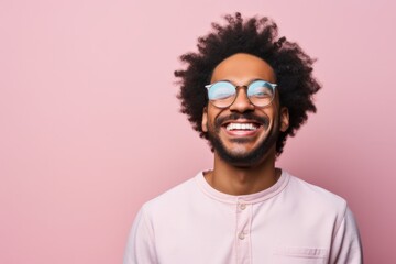 Fototapeta premium Portrait of a joyful afro-american man in his 30s smiling at the camera isolated in pastel or soft colors background