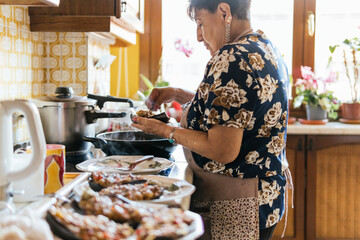 Elderly Woman Preparing Meal in Sunny Kitchen