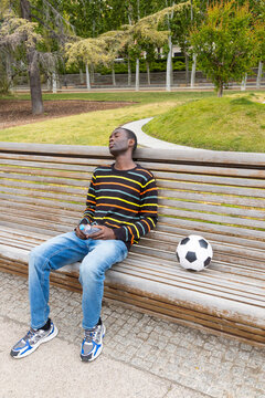 Young man experiencing a hypoglycemic episode on park bench