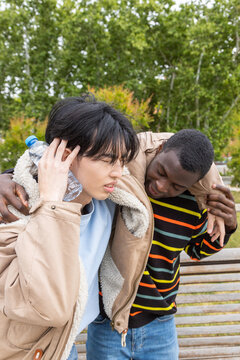 Man comforting woman during a hypoglycemic episode outdoors