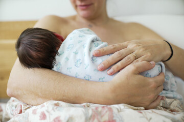Close-up of a mother cradling her newborn baby, highlighting the tender care and protective embrace...