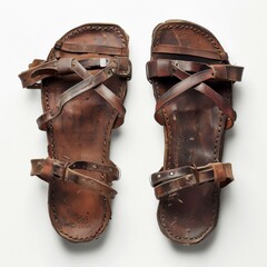 Pair of brown leather Roman sandals isolated on white background